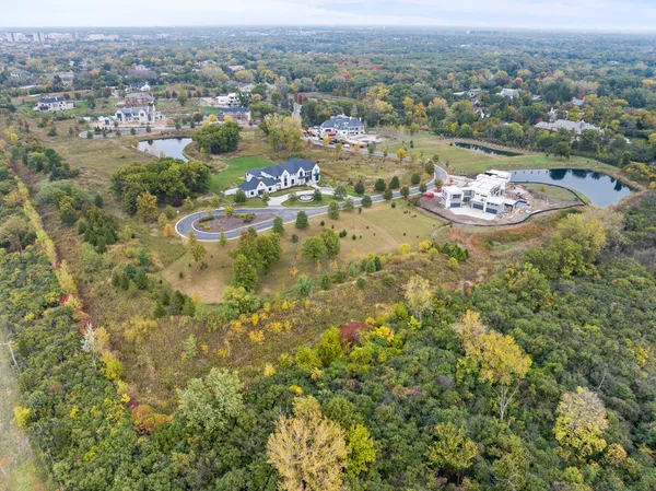 an aerial view of a houses with a lake view