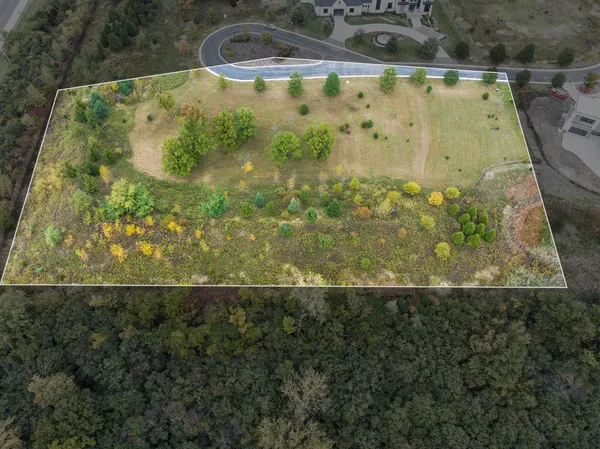 an aerial view of residential house with swimming pool