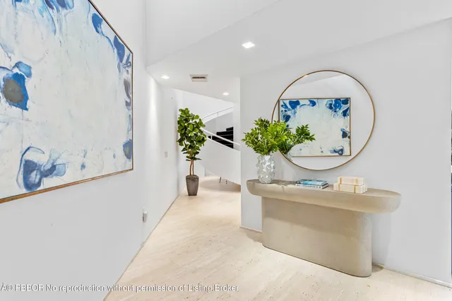 a living room with furniture and a mirror