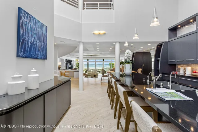 a kitchen with lots of counter space and painting on the wall