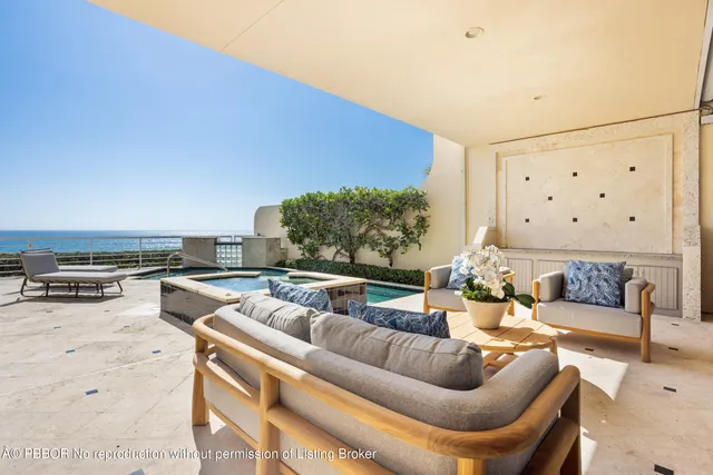 a living room with furniture stove and kitchen view