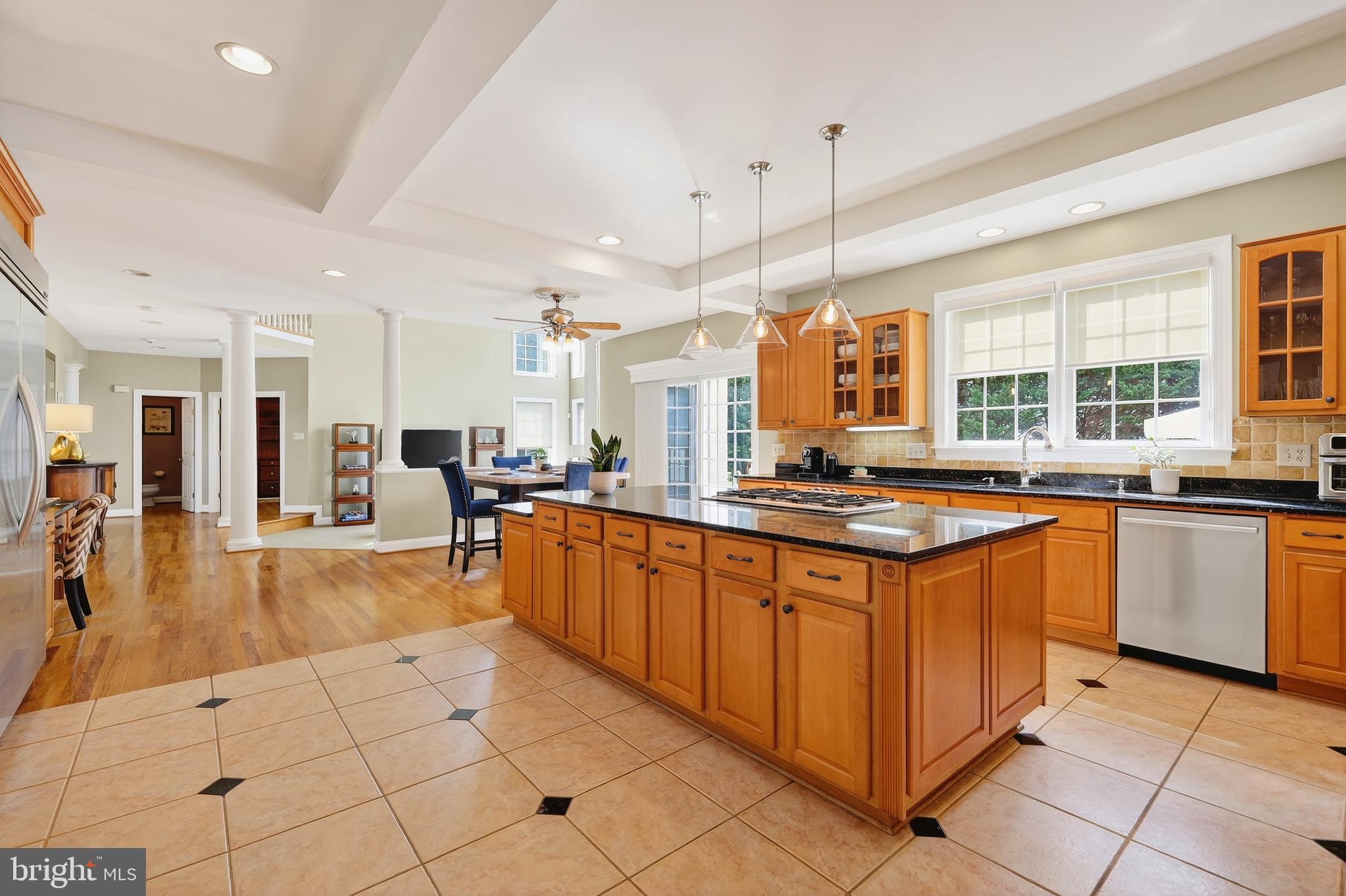 7221 Preservation Court Fulton, MD 20759 - Photo 21 of 69 a large kitchen with kitchen island granite countertop a large counter top and stainless steel appliances