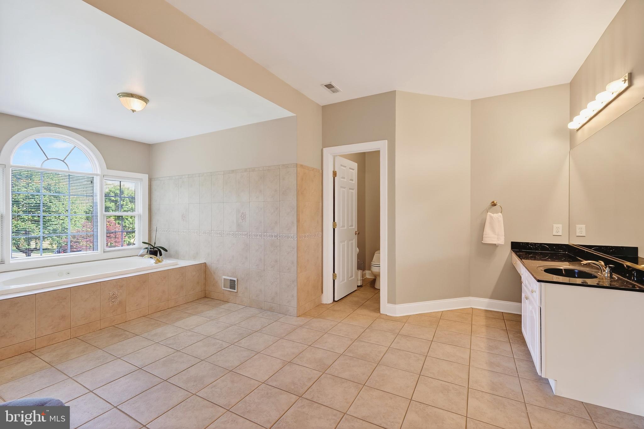 7221 Preservation Court Fulton, MD 20759 - Photo 33 of 69 a kitchen with granite countertop a stove and a refrigerator