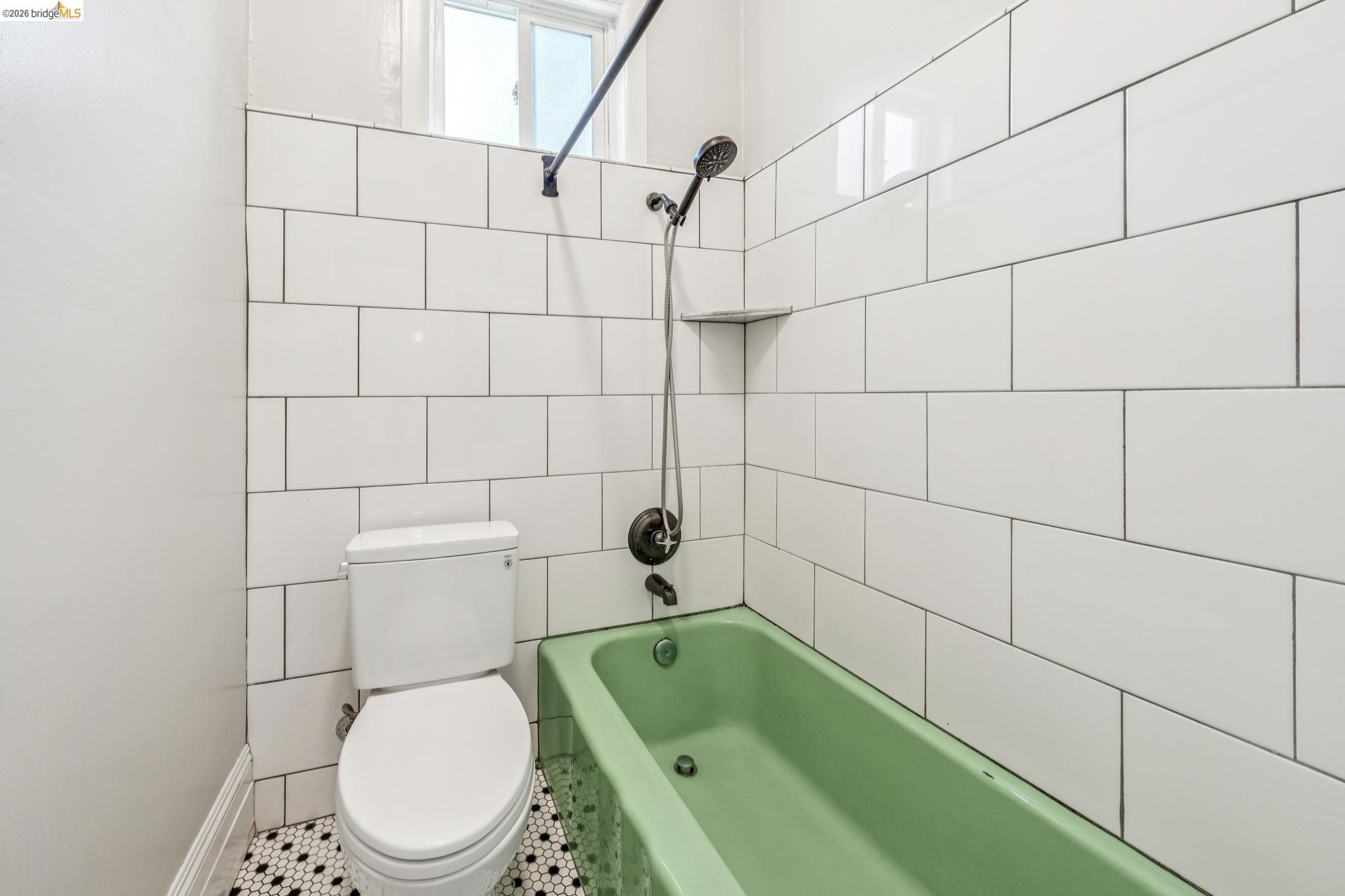 836 20th Street Oakland, CA 94607 - Photo 18 of 54 a bathroom with a toilet a sink and bathtub