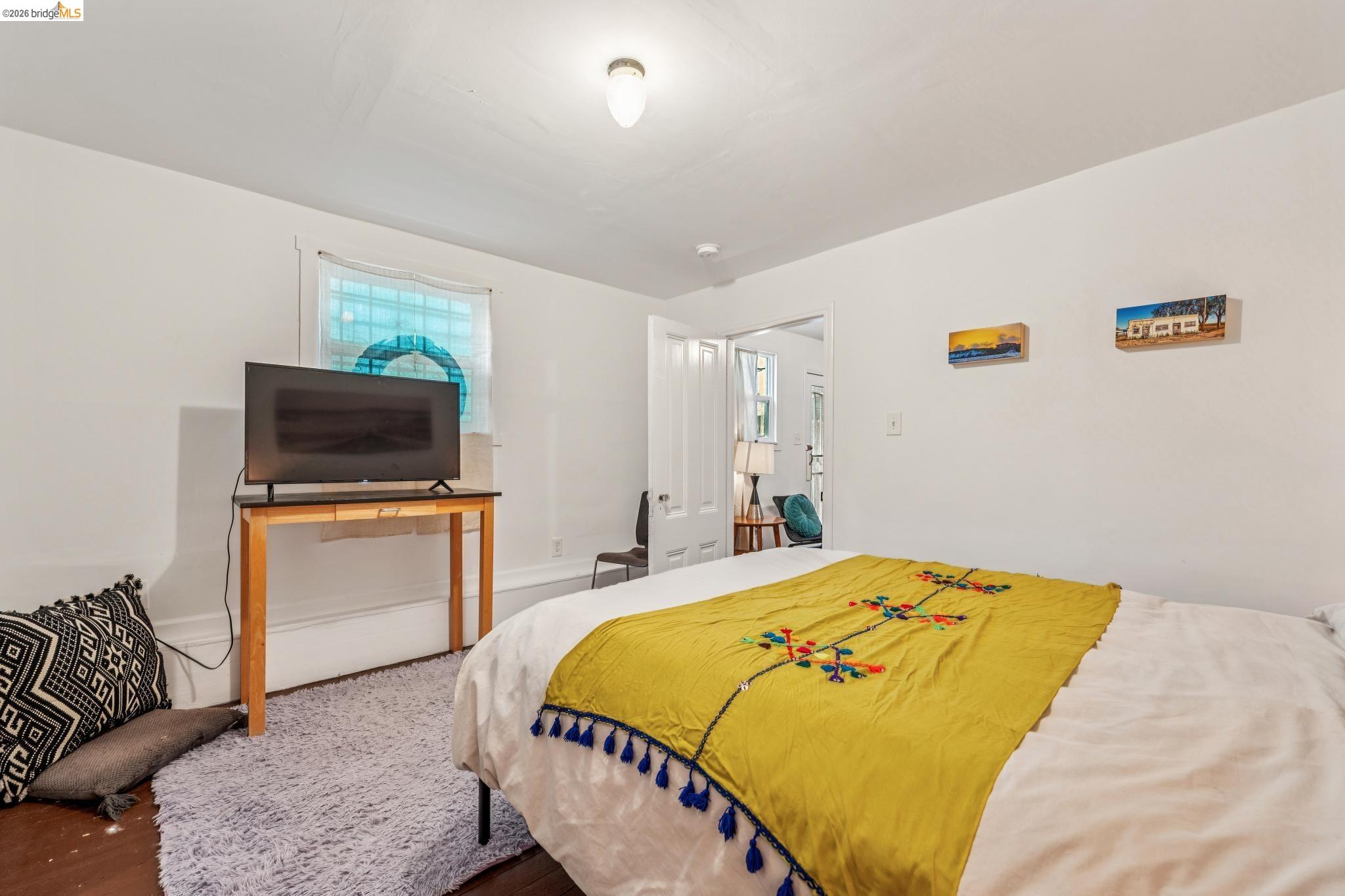 836 20th Street Oakland, CA 94607 - Photo 33 of 54 a bedroom with a bed and a flat screen tv