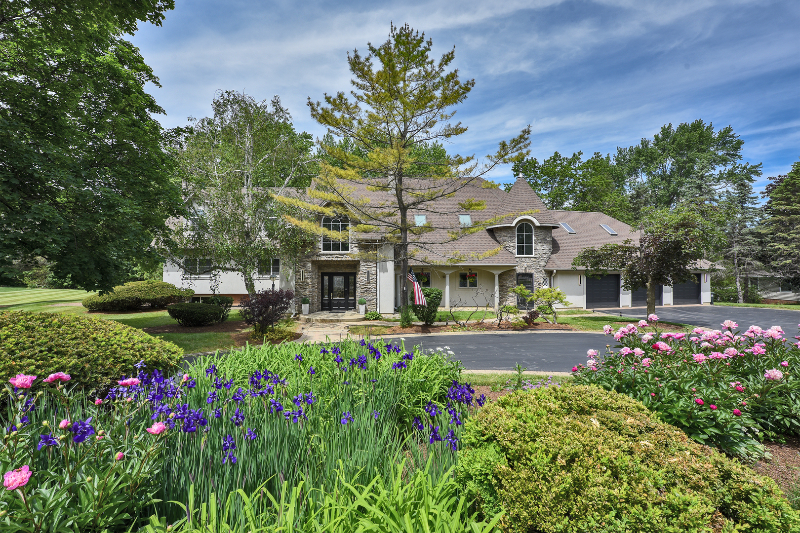a view of a house with a yard and garden