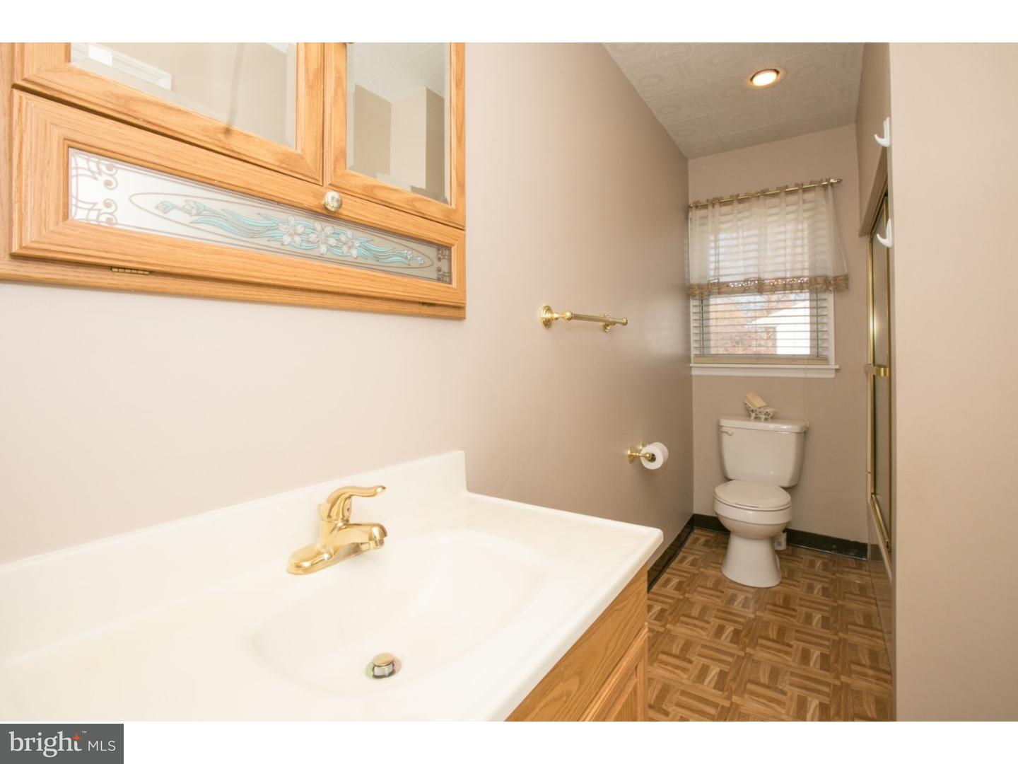 34 South Bell Road Bellmawr, NJ 08031 - Photo 22 of 25 a bathroom with a sink a toilet and a mirror