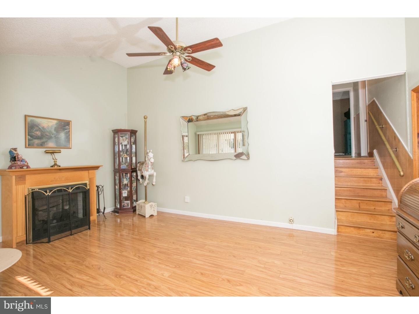 34 South Bell Road Bellmawr, NJ 08031 - Photo 8 of 25 a view of a livingroom with a fireplace a ceiling fan and wooden floor