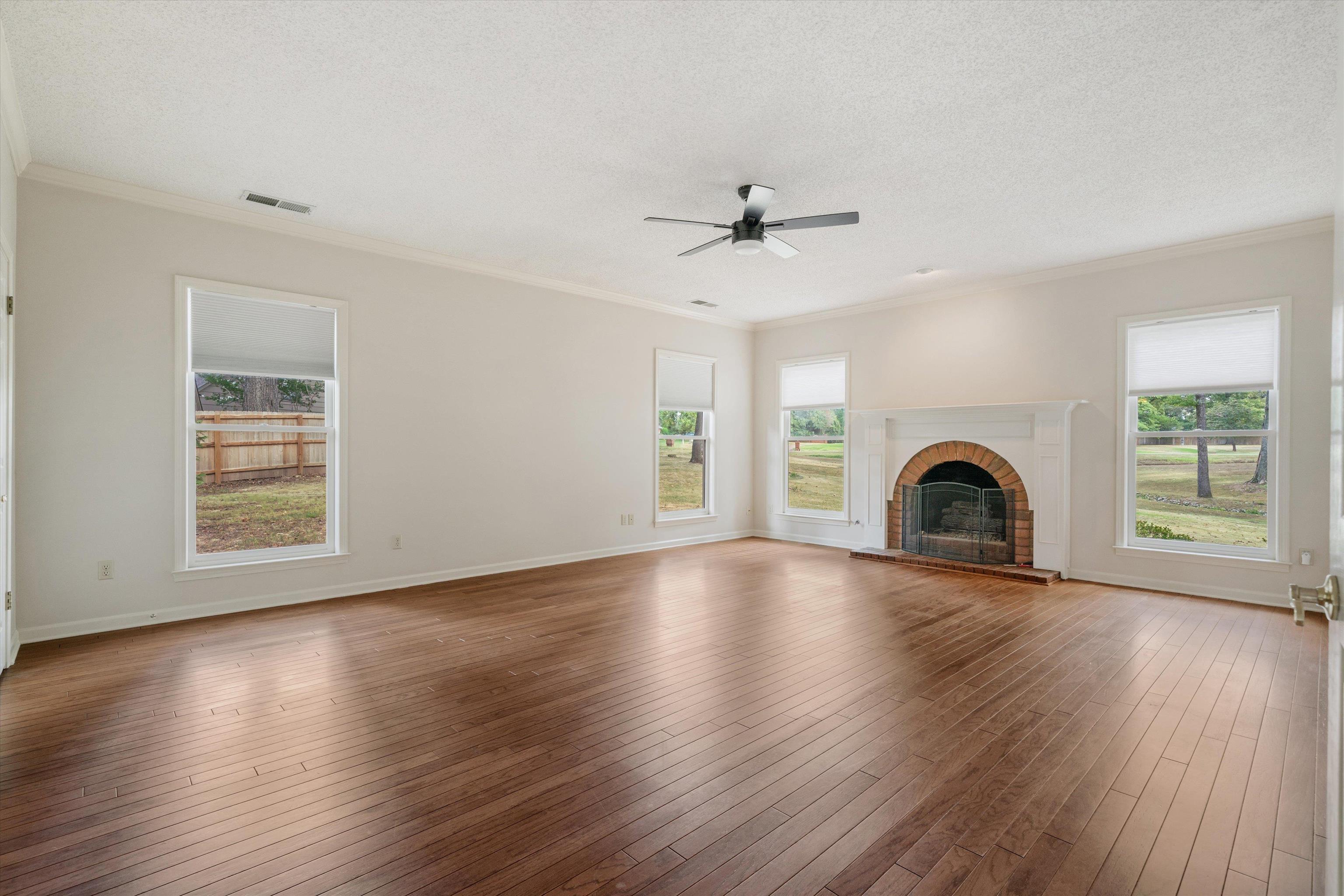 4309 Garner Place Bartlett, TN 38135 - Photo 13 of 40 a view of empty room with wooden floor and fireplace