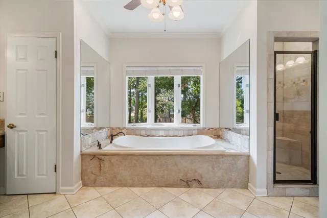 a bath tub sitting in a bathroom next to a window