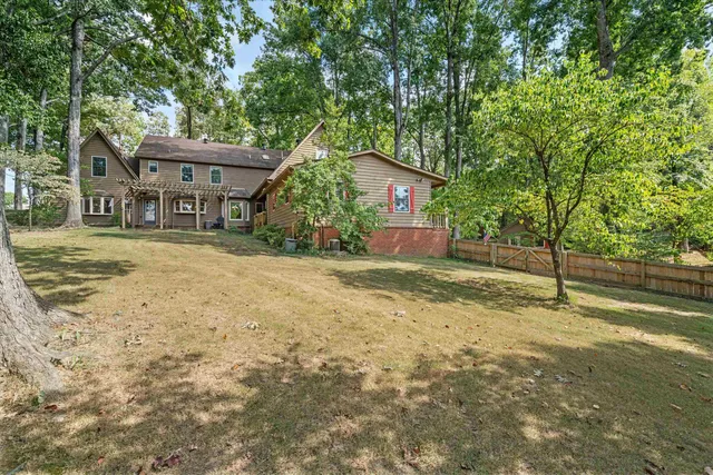 a view of a house with a tree in the yard