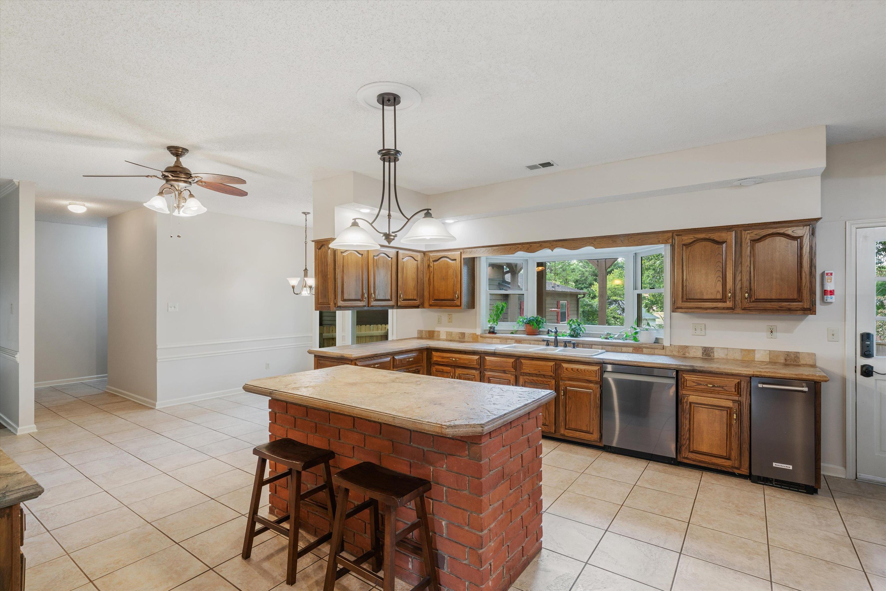 4309 Garner Place Bartlett, TN 38135 - Photo 5 of 40 a kitchen with stainless steel appliances granite countertop a sink and a refrigerator