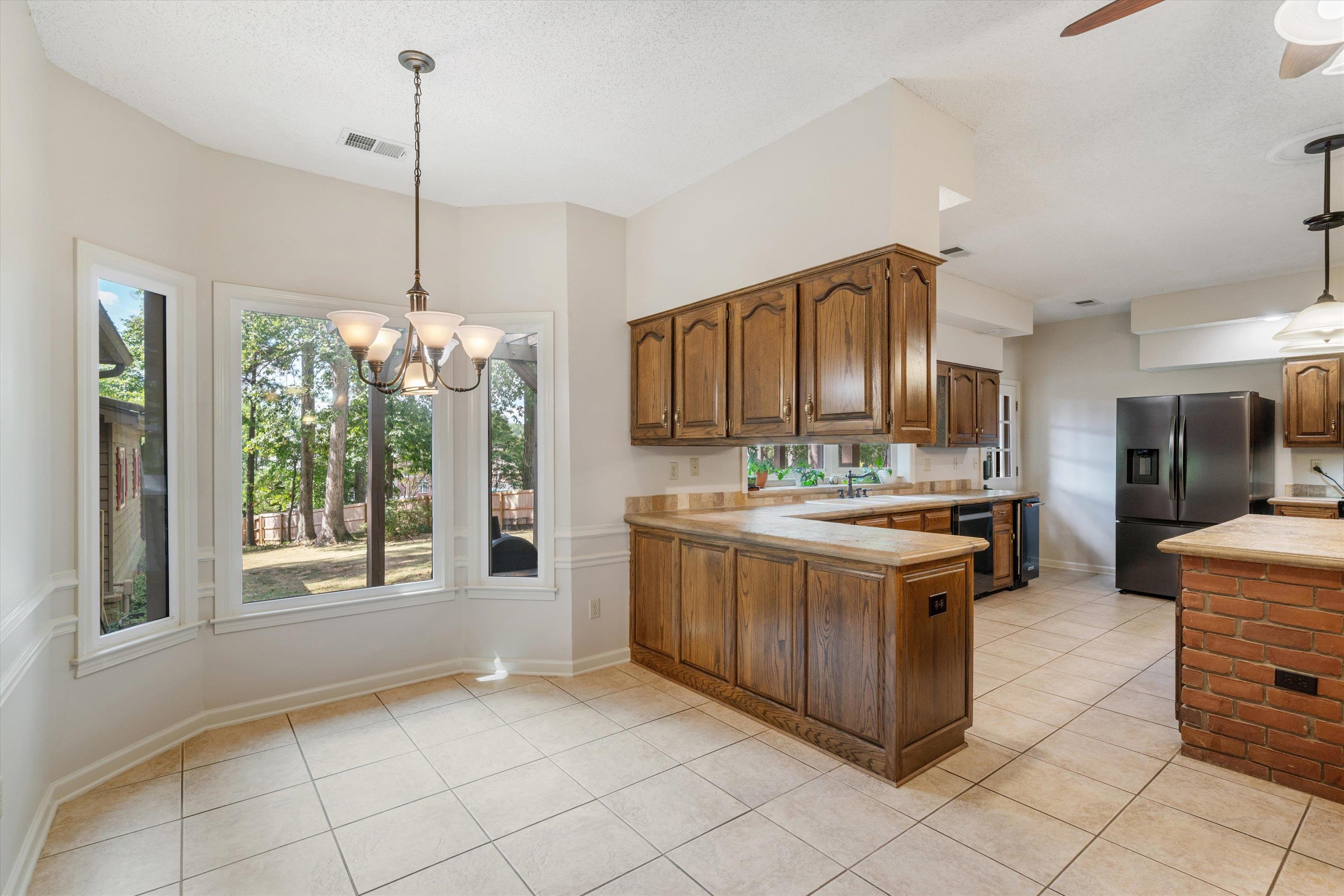 4309 Garner Place Bartlett, TN 38135 - Photo 8 of 40 a kitchen with stainless steel appliances granite countertop a stove and a wooden cabinets