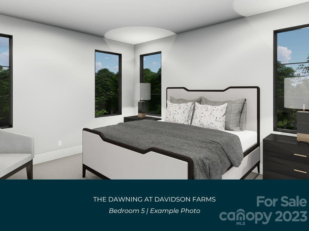 21119 Vandrake Circle, Unit 7 Davidson, NC 28036 - Photo 29 of 33 a large bed sitting in a bedroom next to a window with lamp