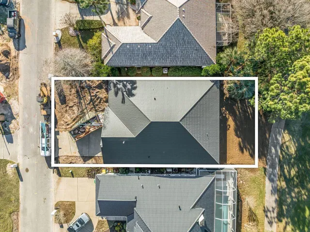 an aerial view of a house with a yard