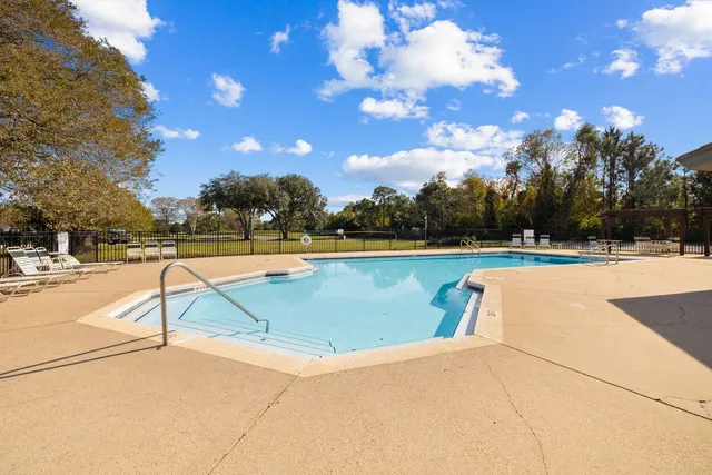 a view of swimming pool with outdoor seating and plants