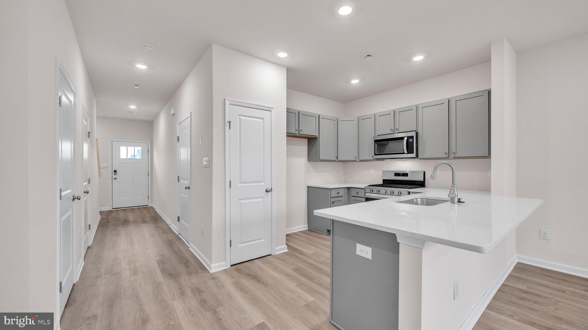 29 Alexander Way Westampton, NJ 08060 - Photo 3 of 14 a kitchen with stainless steel appliances a refrigerator a sink dishwasher and a stove top oven