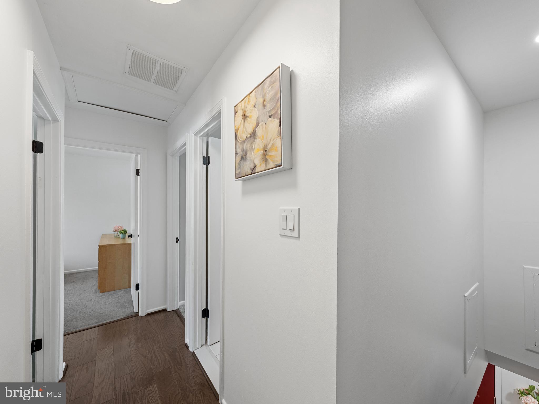 8448 Kitchener Drive Springfield, VA 22153 - Photo 13 of 32 a view of a hallway with wooden floor