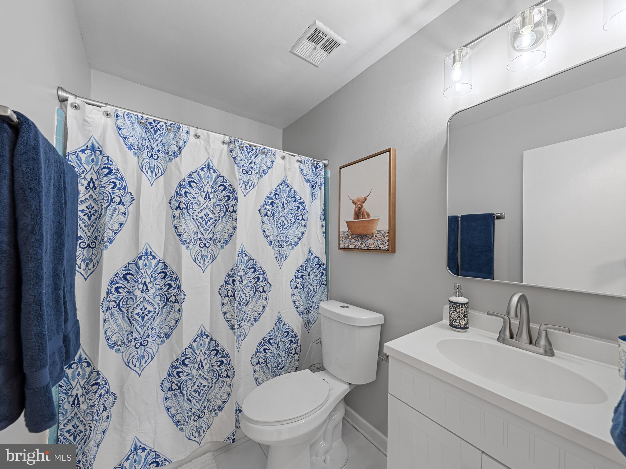 8448 Kitchener Drive Springfield, VA 22153 - Photo 21 of 32 a white toilet sitting next to a bathroom sink