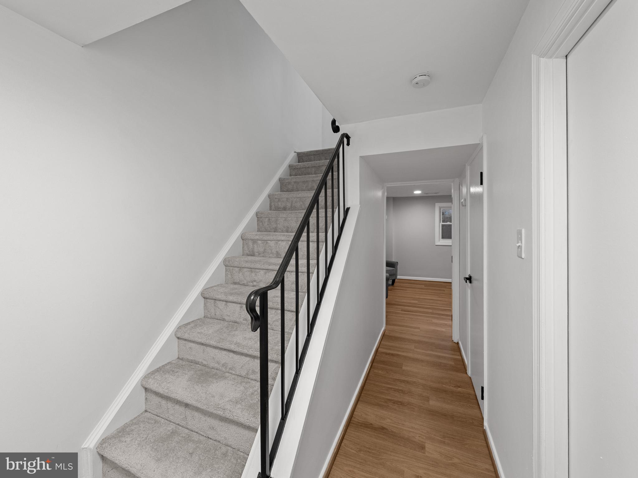 8448 Kitchener Drive Springfield, VA 22153 - Photo 23 of 32 a view of a hallway with wooden floor and stairs