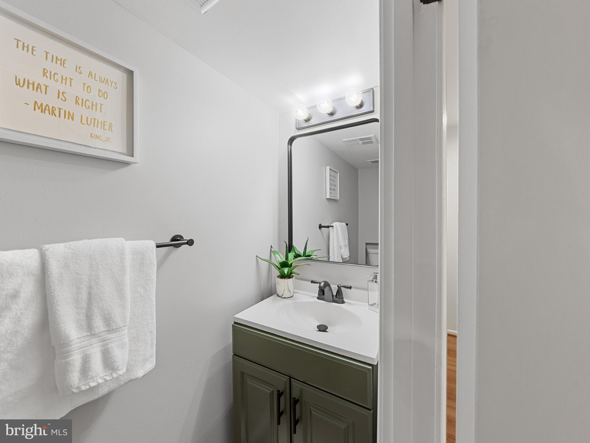 8448 Kitchener Drive Springfield, VA 22153 - Photo 24 of 32 a bathroom with a sink and a mirror