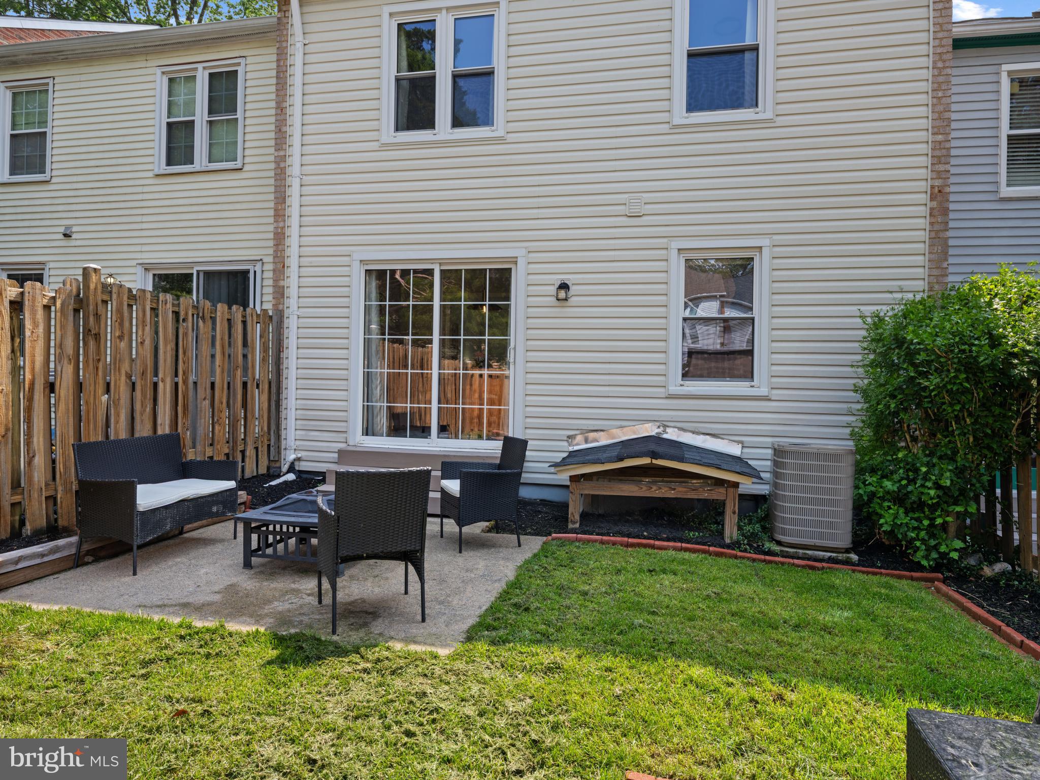 8448 Kitchener Drive Springfield, VA 22153 - Photo 28 of 32 a backyard of a house with outdoor seating