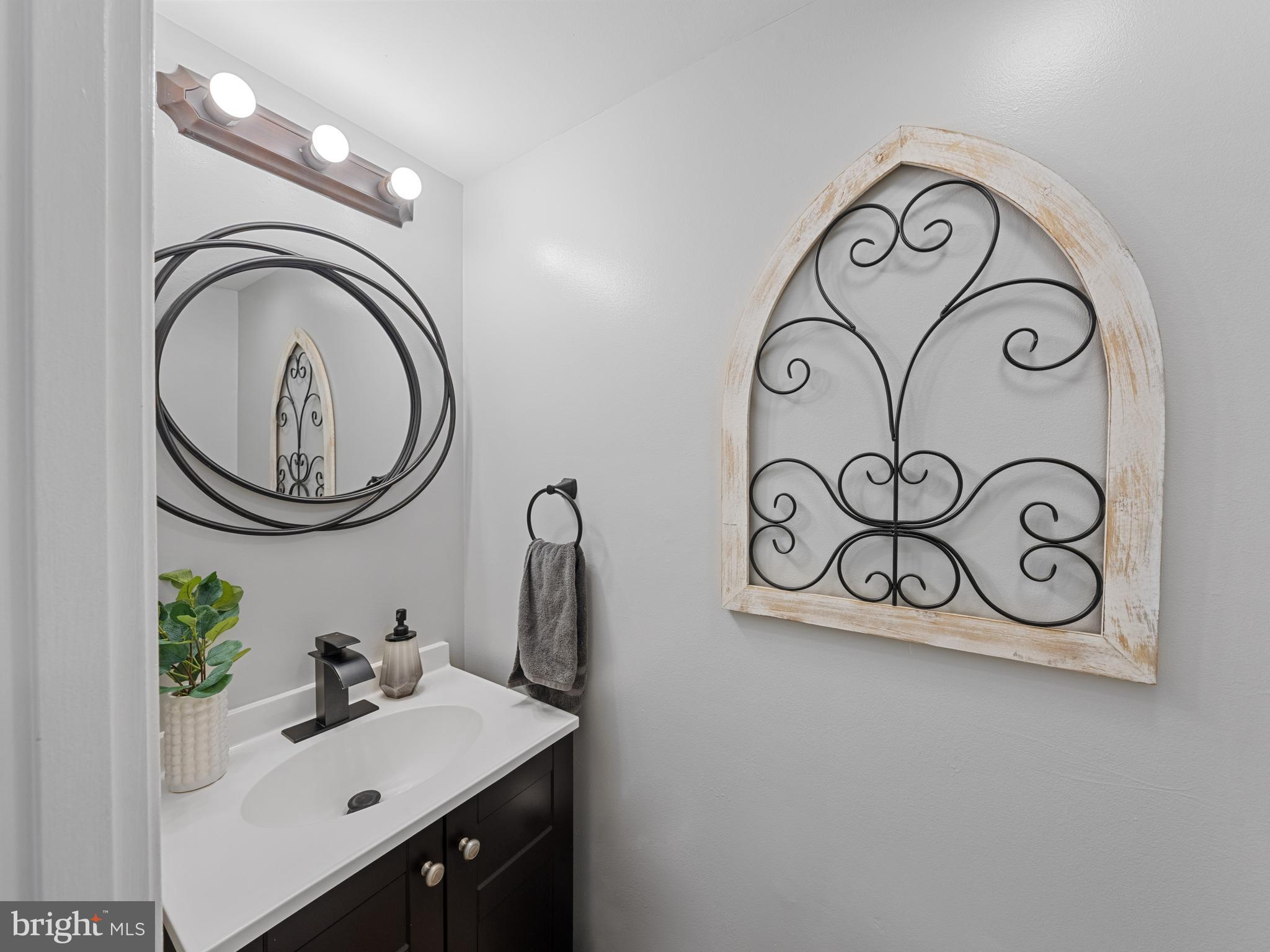 8448 Kitchener Drive Springfield, VA 22153 - Photo 5 of 32 a bathroom with a sink and a mirror