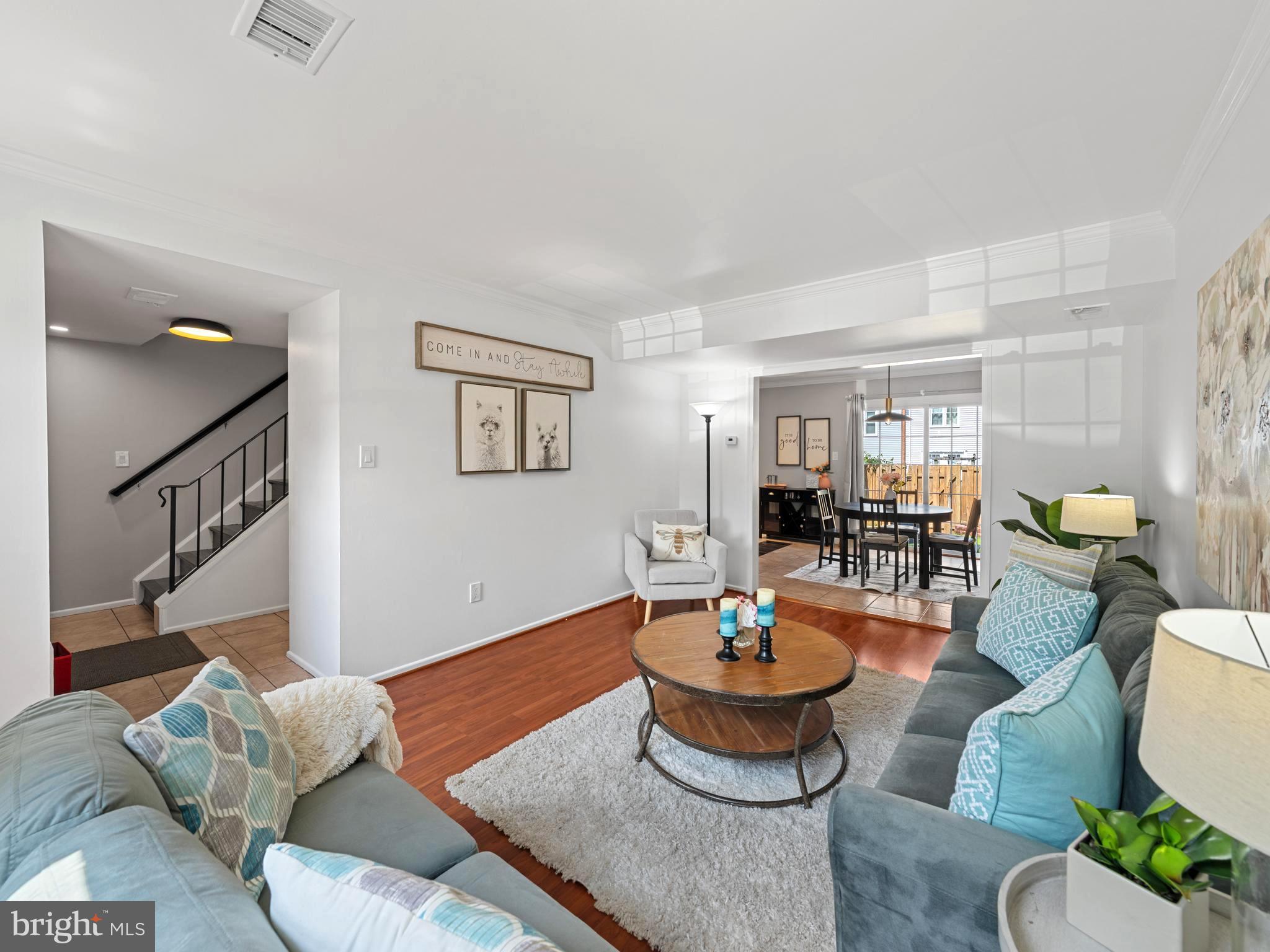 8448 Kitchener Drive Springfield, VA 22153 - Photo 8 of 32 a living room with furniture potted plant and wooden floor