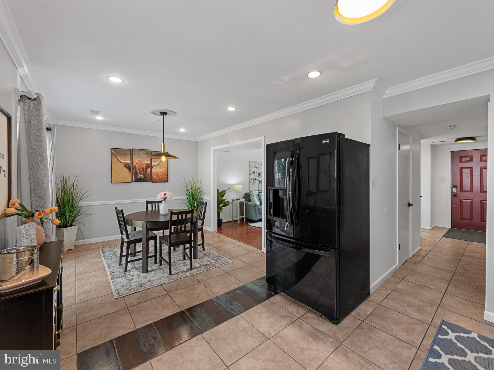 8448 Kitchener Drive Springfield, VA 22153 - Photo 10 of 32 a kitchen with stainless steel appliances granite countertop a refrigerator and a dining table