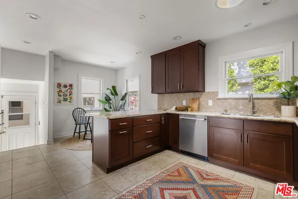 a kitchen with stainless steel appliances granite countertop a sink and cabinets