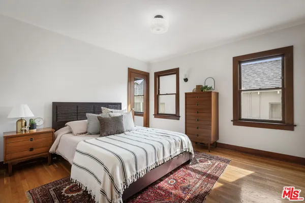 a bedroom with a bed next to a window