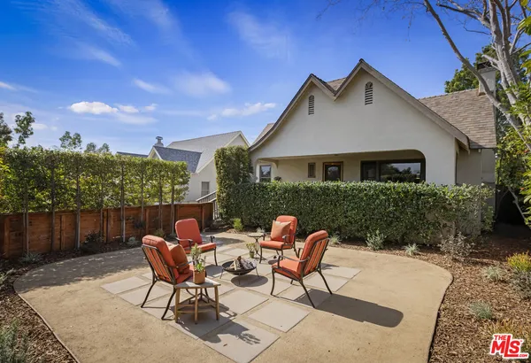 a view of a patio with table and chairs and potted plants