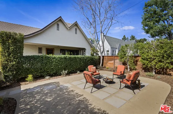 a view of a house with backyard and sitting area