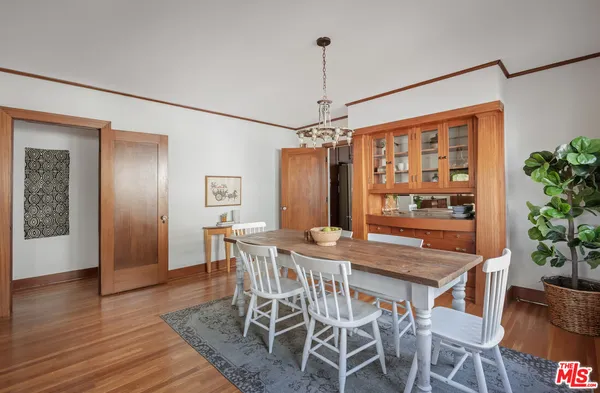 a dining room with furniture window and wooden floor