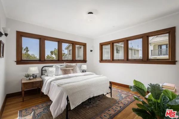 a bedroom with bed and a window