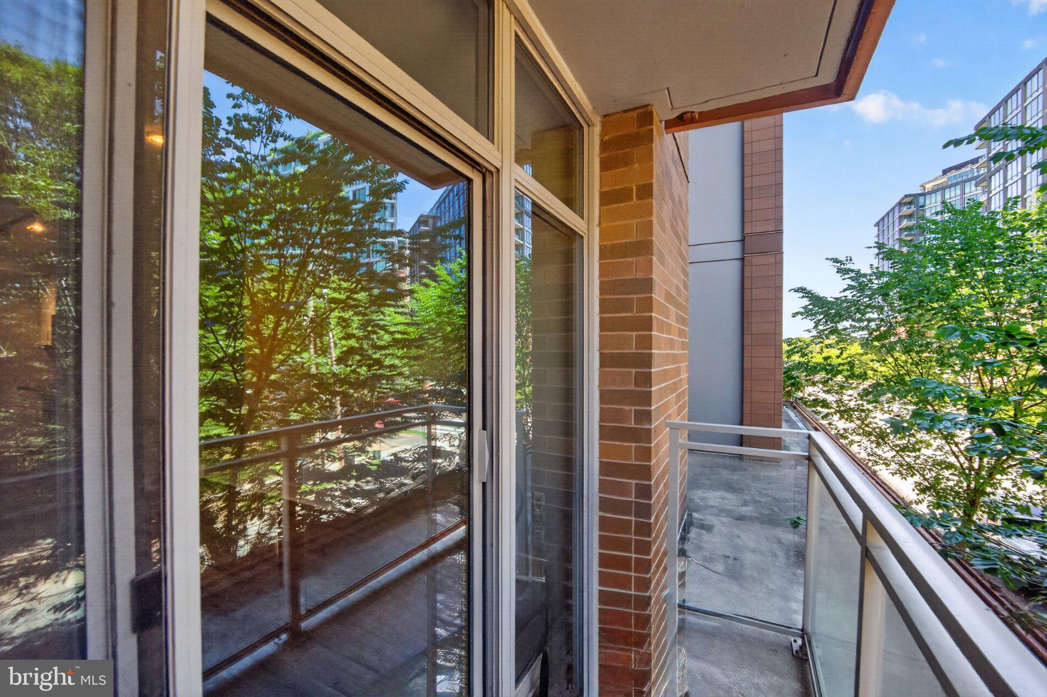 88 V Street Southwest, Unit 213 Washington, DC 20024 - Photo 24 of 26 Serene balcony with lush greenery views.