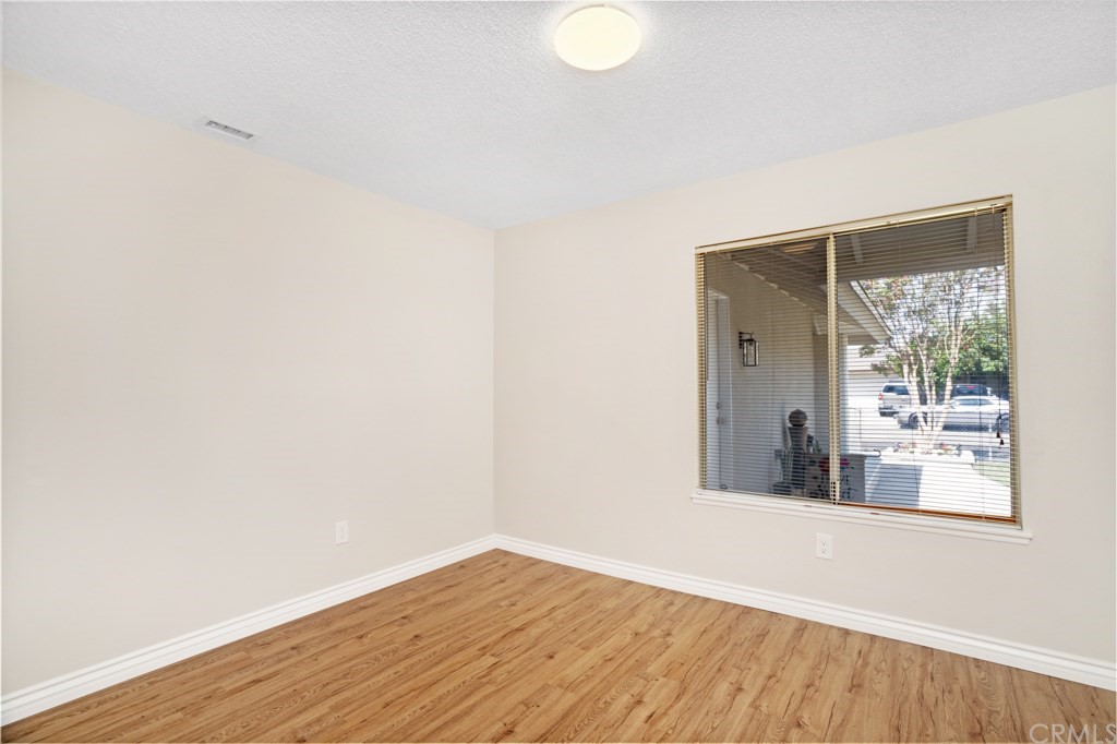 7920 Temecula Place Riverside, CA 92503 - Photo 17 of 34 a view of an empty room with wooden floor and a window