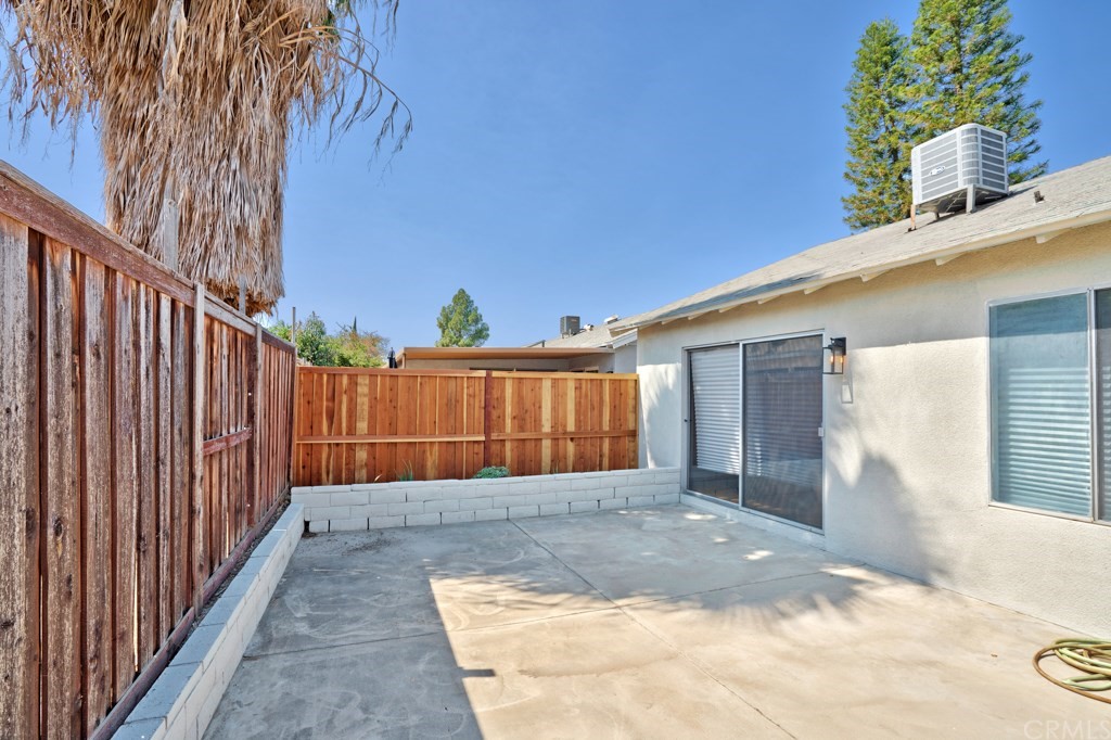 7920 Temecula Place Riverside, CA 92503 - Photo 24 of 34 a view of backyard with small cabin and wooden fence