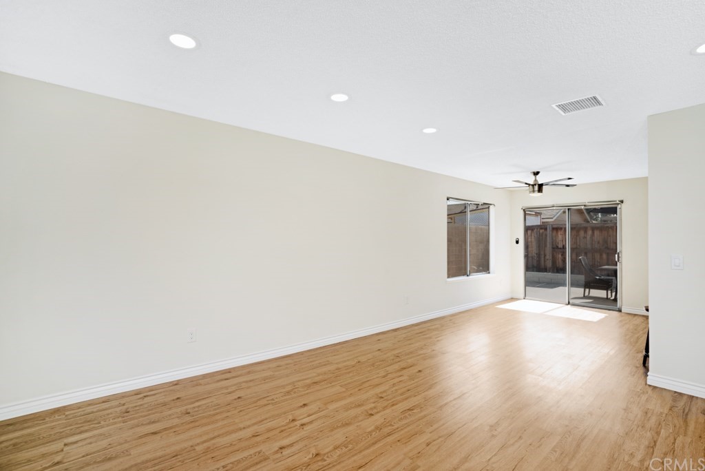 7920 Temecula Place Riverside, CA 92503 - Photo 9 of 34 an empty room with wooden floor and windows