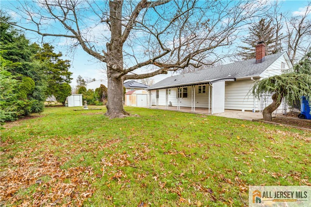 1474 Huron Road North Brunswick, NJ 08902 - Photo 11 of 16 a house that has a tree in front of the house
