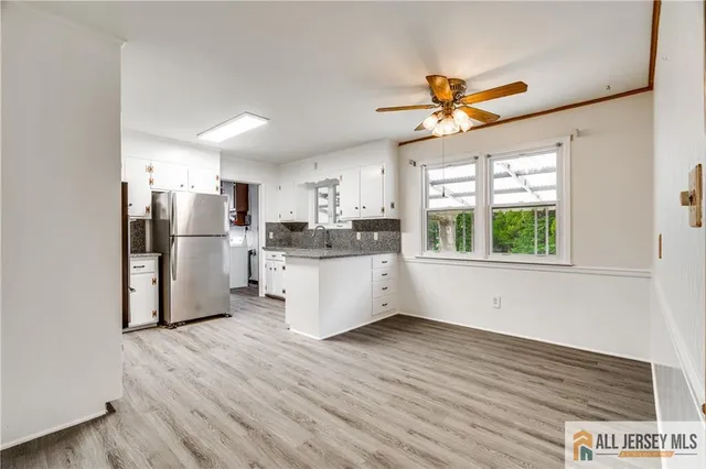 a kitchen with stainless steel appliances a refrigerator and a stove top oven