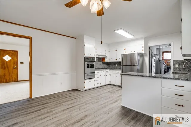 a kitchen with stainless steel appliances a refrigerator sink and cabinets