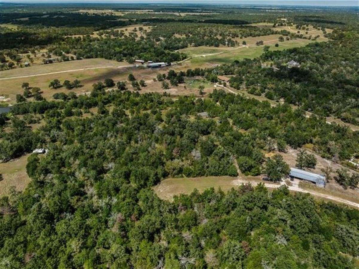 an aerial view of a houses with a yard