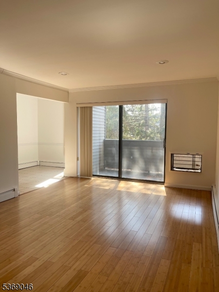 21 River Road, Unit G Nutley, NJ 07110 - Photo 7 of 22 an empty room with wooden floor and windows
