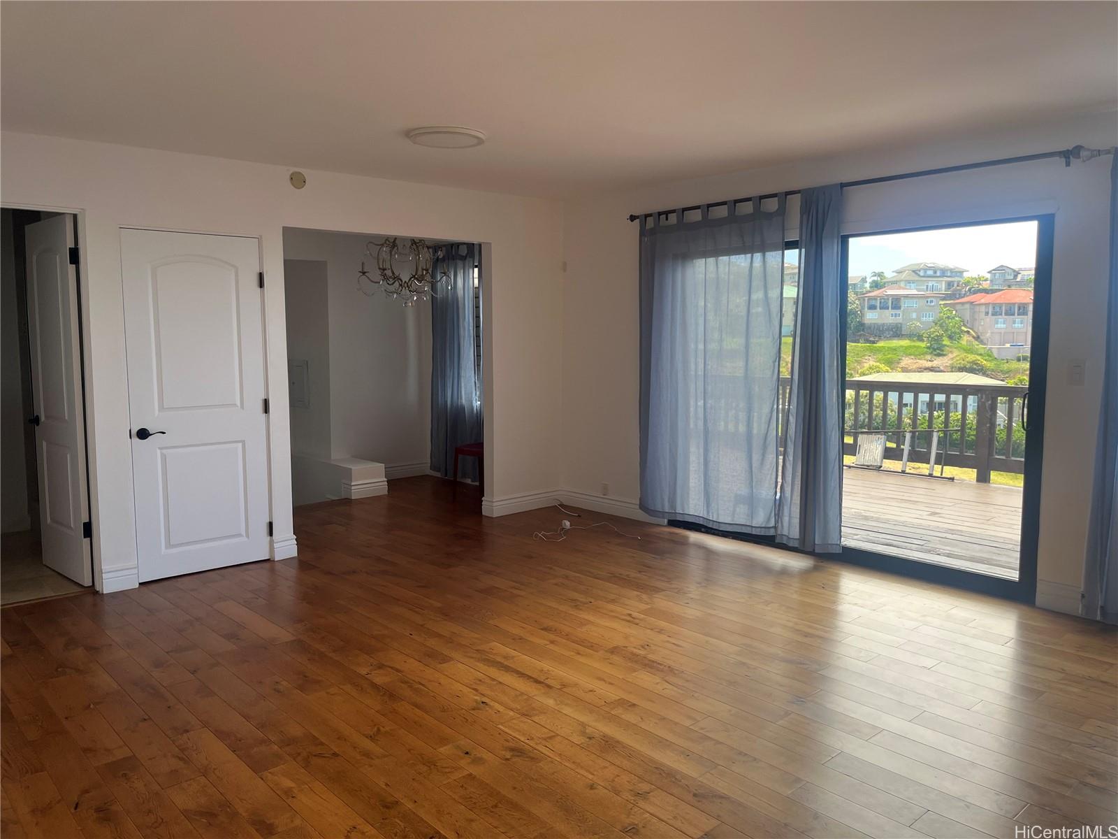 2067 Omea Place Honolulu, HI 96821 - Photo 3 of 9 a view of an empty room with glass door and a window