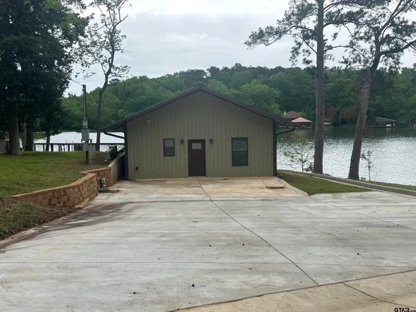a view of a house with a yard and garage