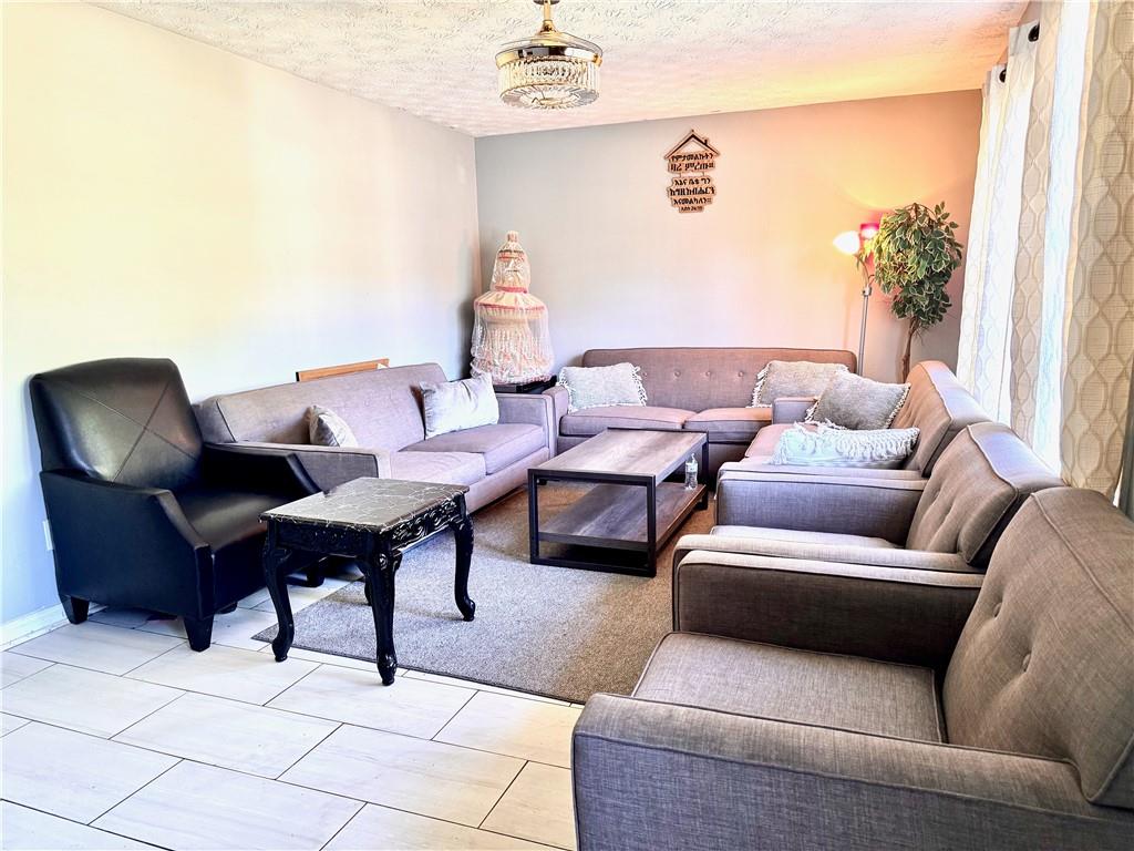 1825 North Road Snellville, GA 30078 - Photo 2 of 43 a living room with furniture and a potted plant