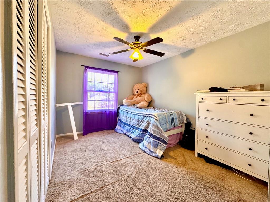 1825 North Road Snellville, GA 30078 - Photo 25 of 43 a bedroom with a bed and a chandelier