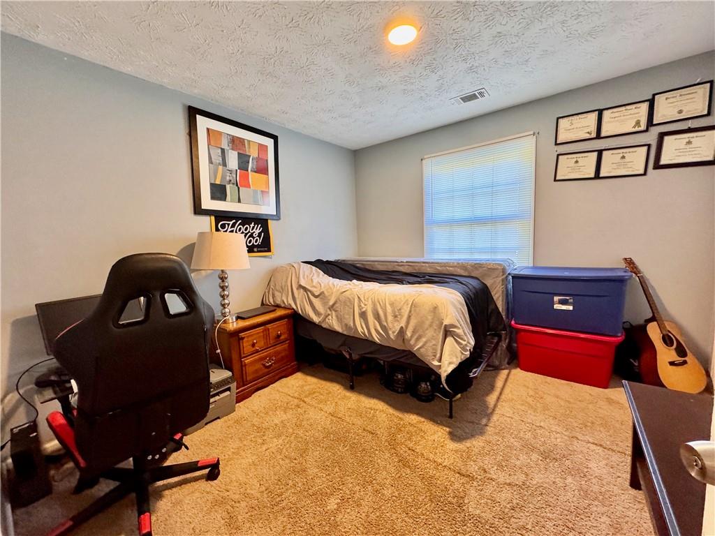 1825 North Road Snellville, GA 30078 - Photo 26 of 43 a bedroom with a bed dresser and window