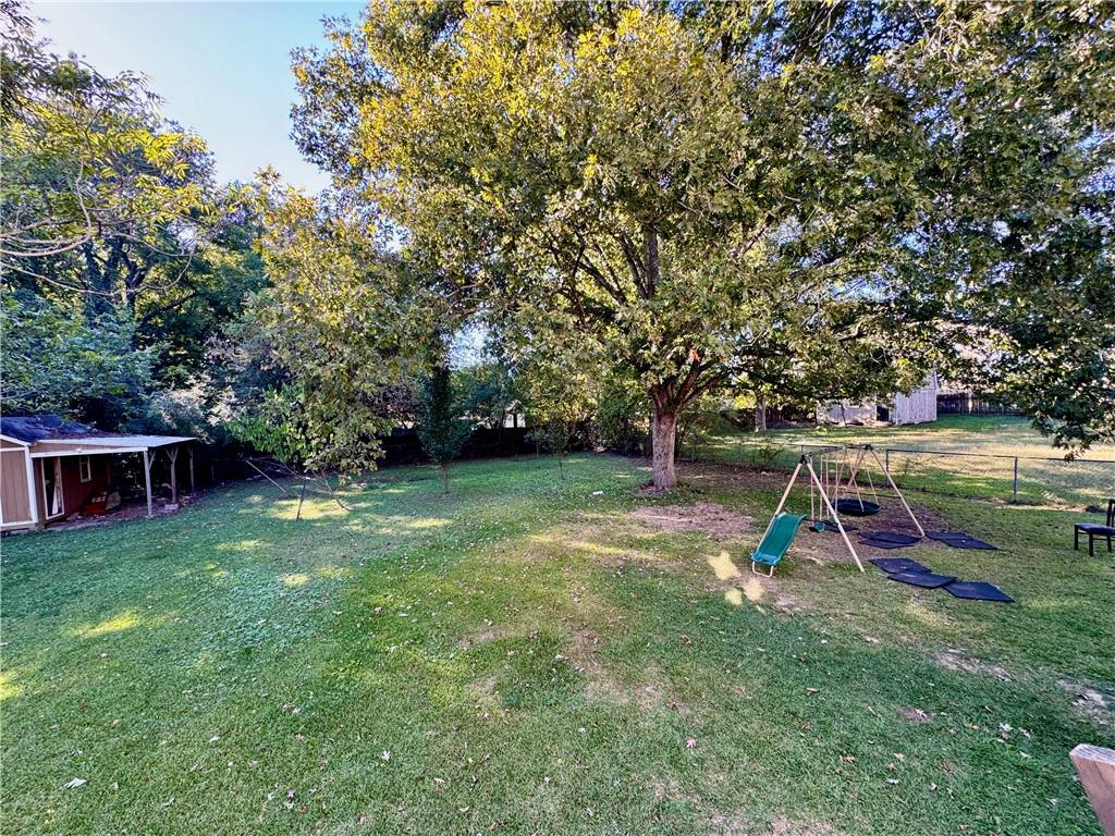 1825 North Road Snellville, GA 30078 - Photo 33 of 43 a view of a backyard with swings and slides